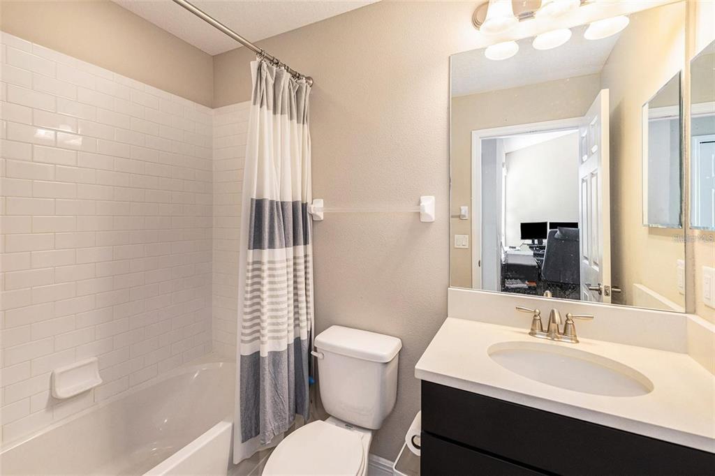 9152 Fox Sparrow Road Tampa, FL 33626 - Photo 19 of 32 a bathroom with a sink a toilet a mirror and shower