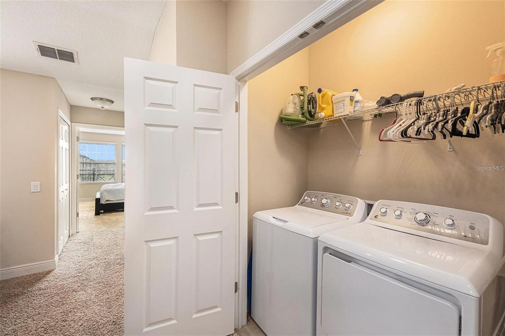 9152 Fox Sparrow Road Tampa, FL 33626 - Photo 20 of 32 a view of washer and dryer with kitchen in the background