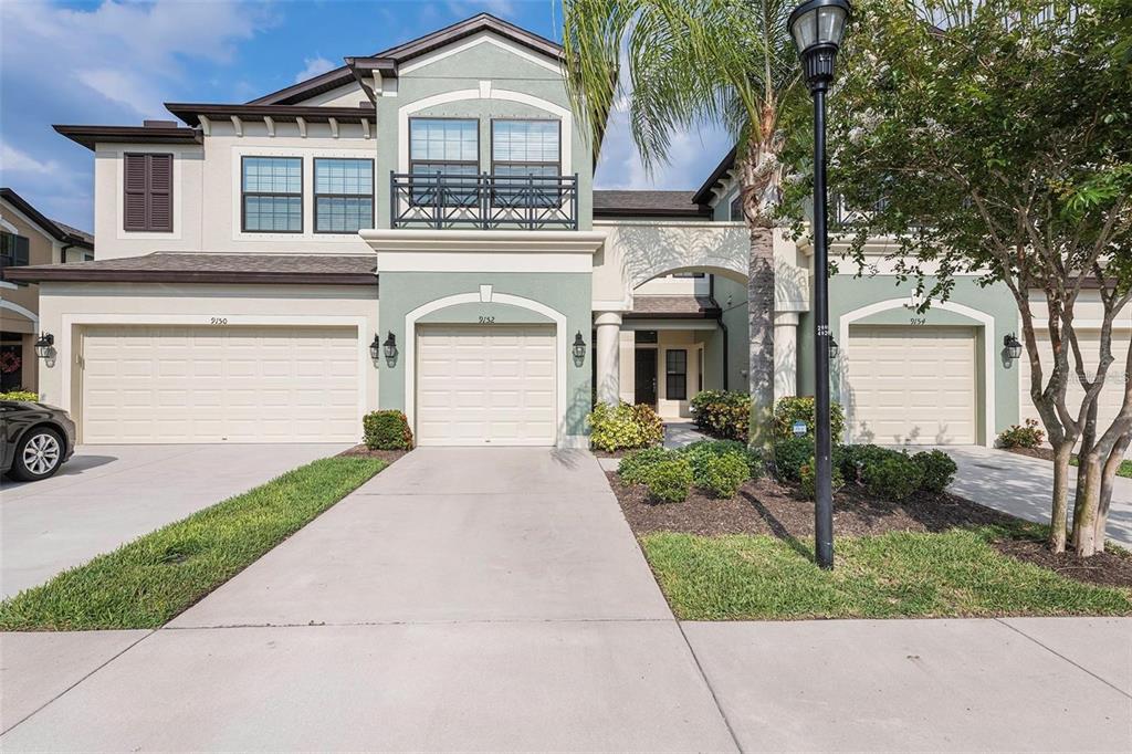 9152 Fox Sparrow Road Tampa, FL 33626 - Photo 24 of 32 a front view of a house with a garden