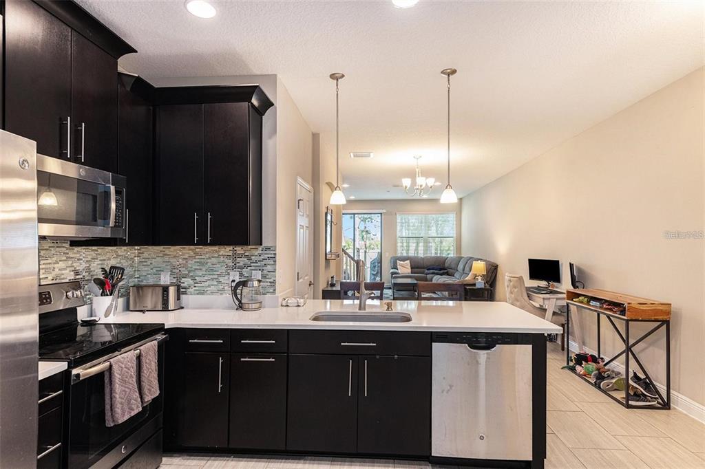 9152 Fox Sparrow Road Tampa, FL 33626 - Photo 5 of 32 a kitchen with stainless steel appliances a sink stove and refrigerator