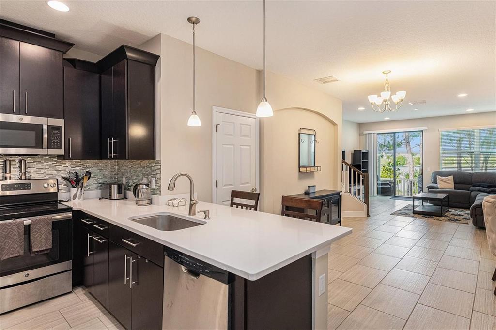 9152 Fox Sparrow Road Tampa, FL 33626 - Photo 7 of 32 a kitchen with a sink a counter space appliances and cabinets