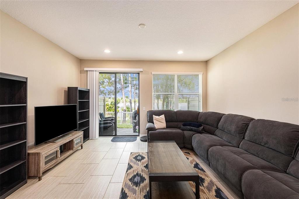 9152 Fox Sparrow Road Tampa, FL 33626 - Photo 9 of 32 a living room with furniture and a flat screen tv