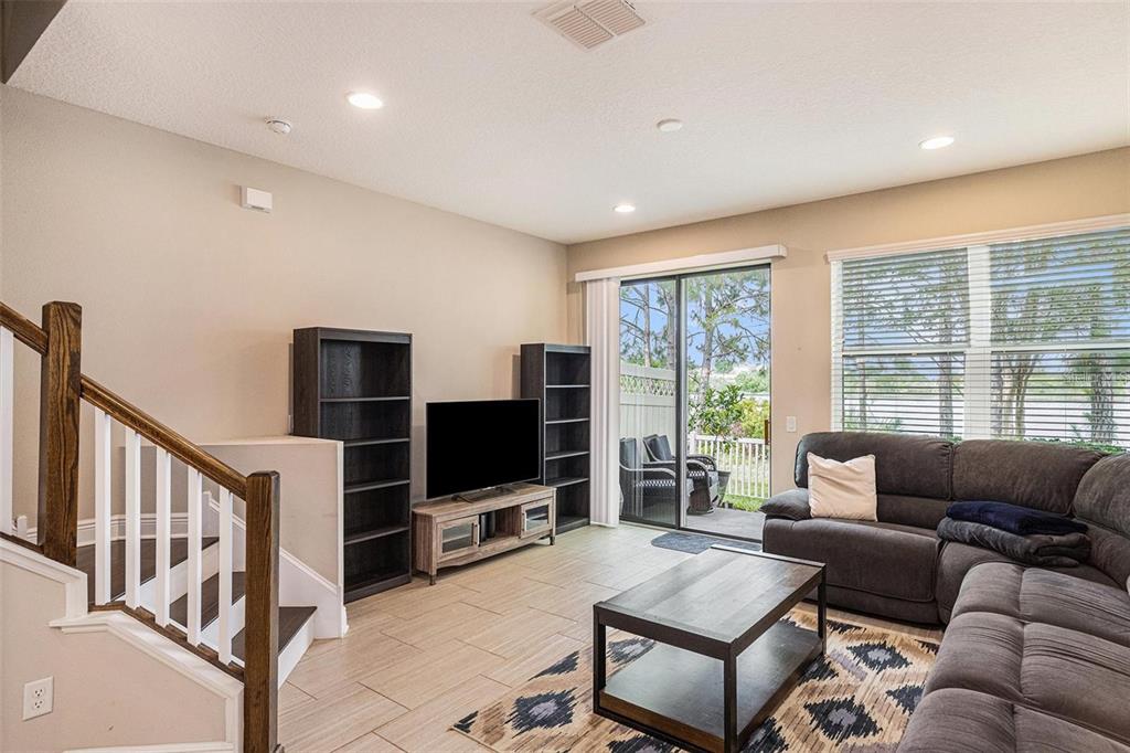 9152 Fox Sparrow Road Tampa, FL 33626 - Photo 10 of 32 a living room with furniture a flat screen tv and a large window