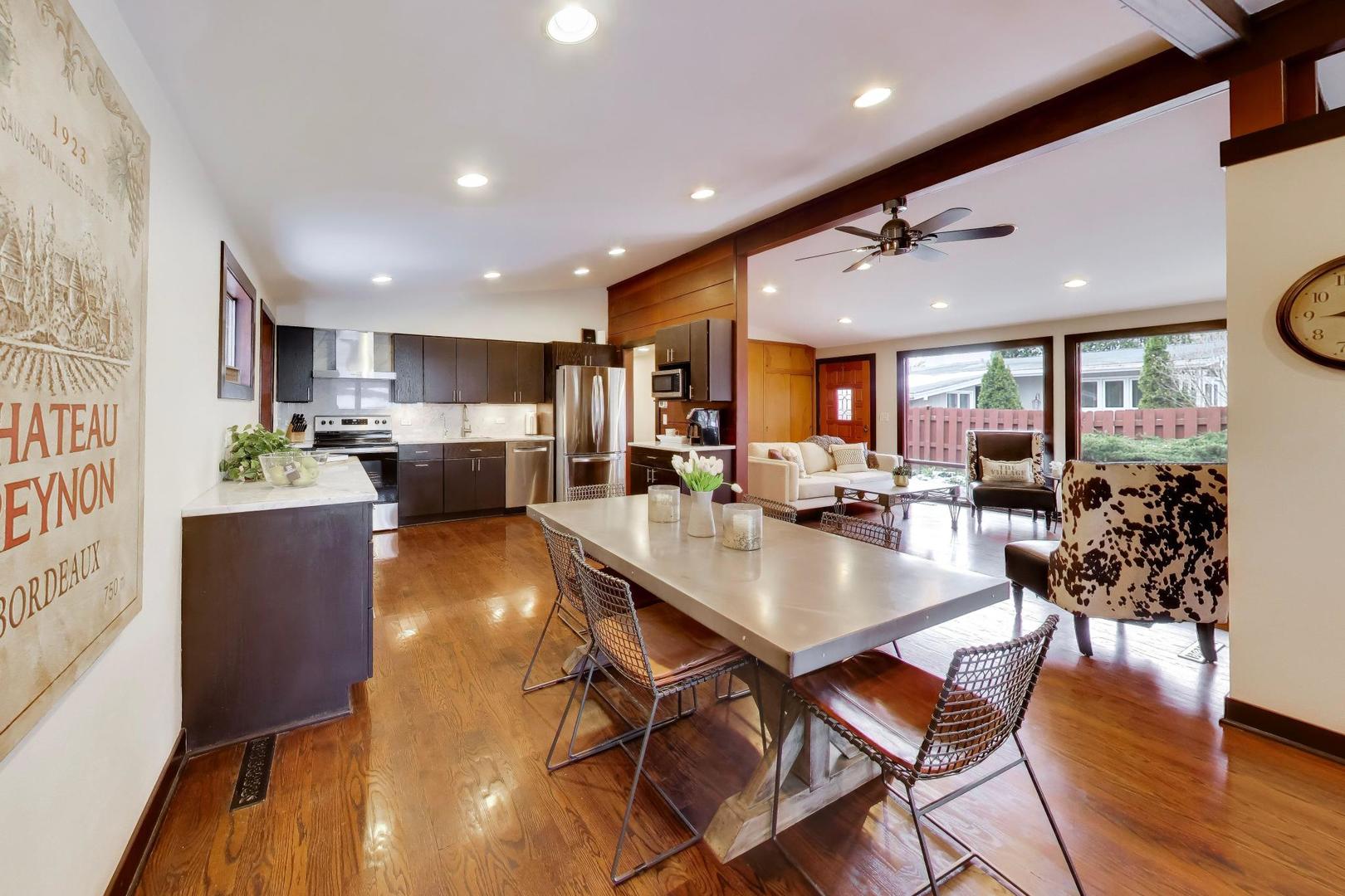 802 Lill Street Barrington, IL 60010 - Photo 4 of 27 a dining room with stainless steel appliances furniture large window and wooden floor
