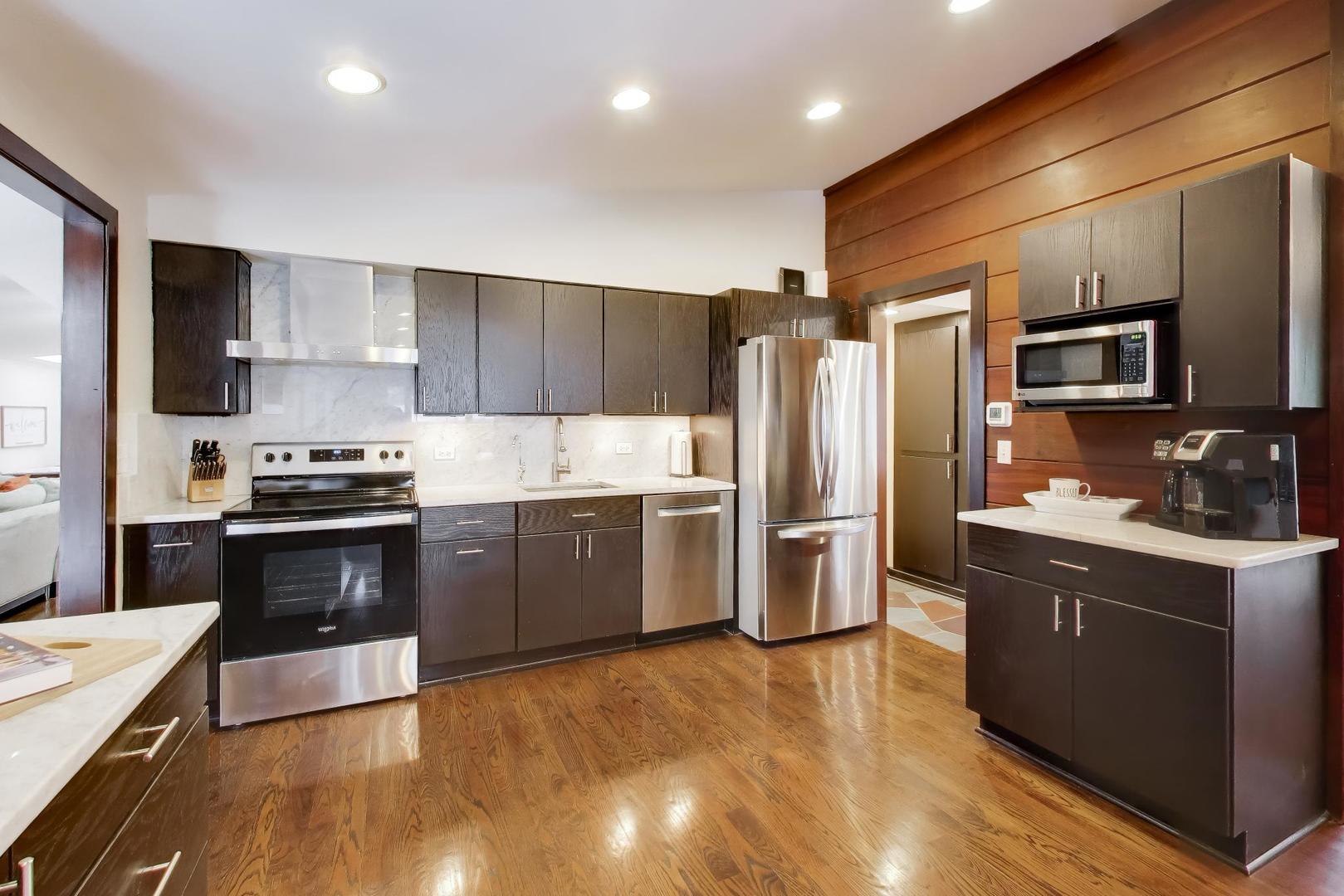 802 Lill Street Barrington, IL 60010 - Photo 5 of 27 a kitchen with granite countertop a refrigerator and a stove top oven