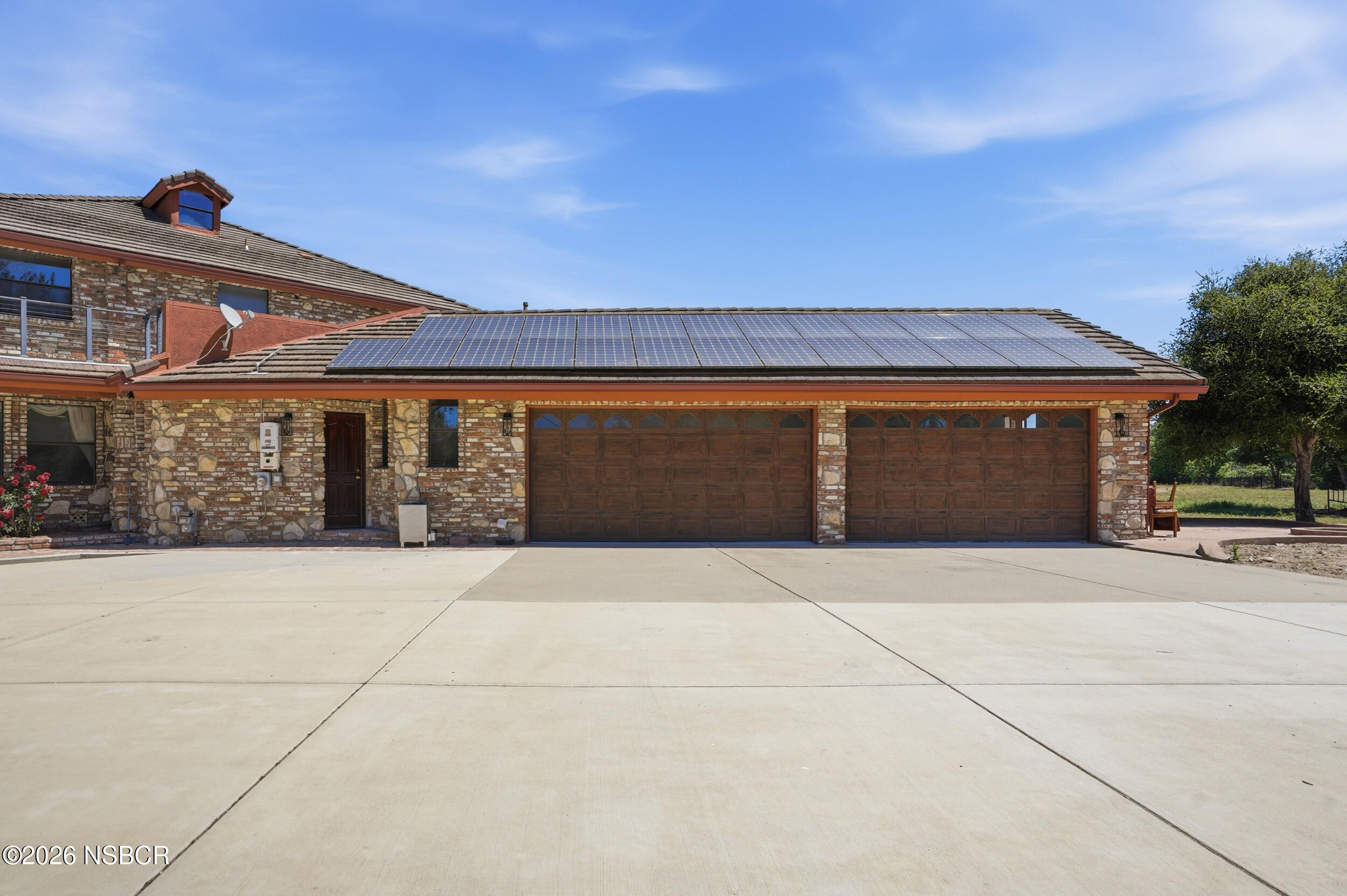140 East Rice Ranch Road Santa Maria, CA 93455 - Photo 4 of 44 a front view of a house with a yard and garage