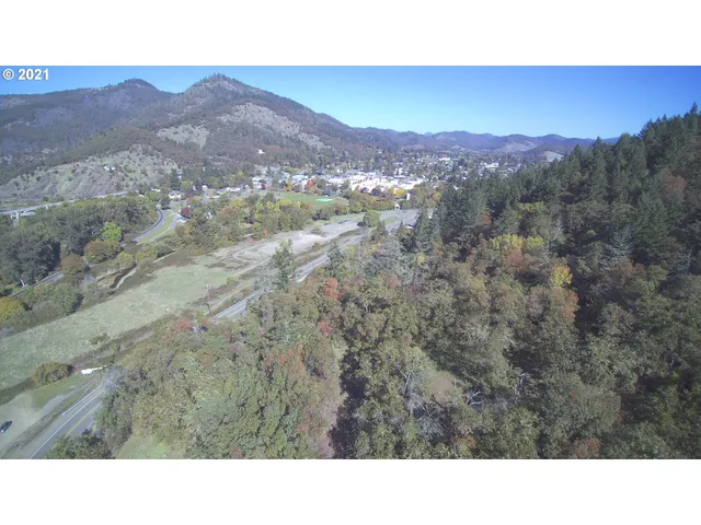 a open area with mountains in the background