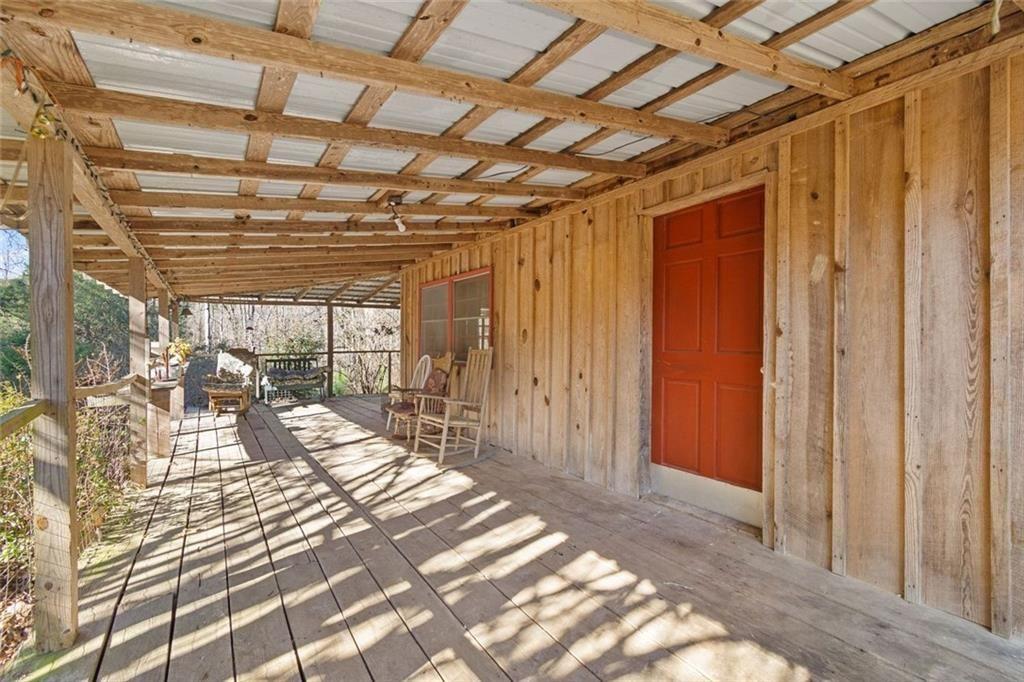 7315 Freeman Road Dawsonville, GA 30534 - Photo 13 of 28 a view of a porch with a table and chairs