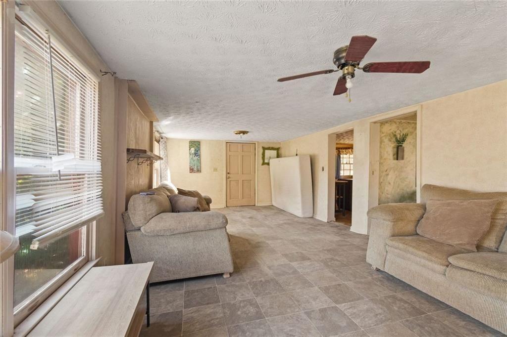 7315 Freeman Road Dawsonville, GA 30534 - Photo 17 of 28 a living room with furniture and a large window