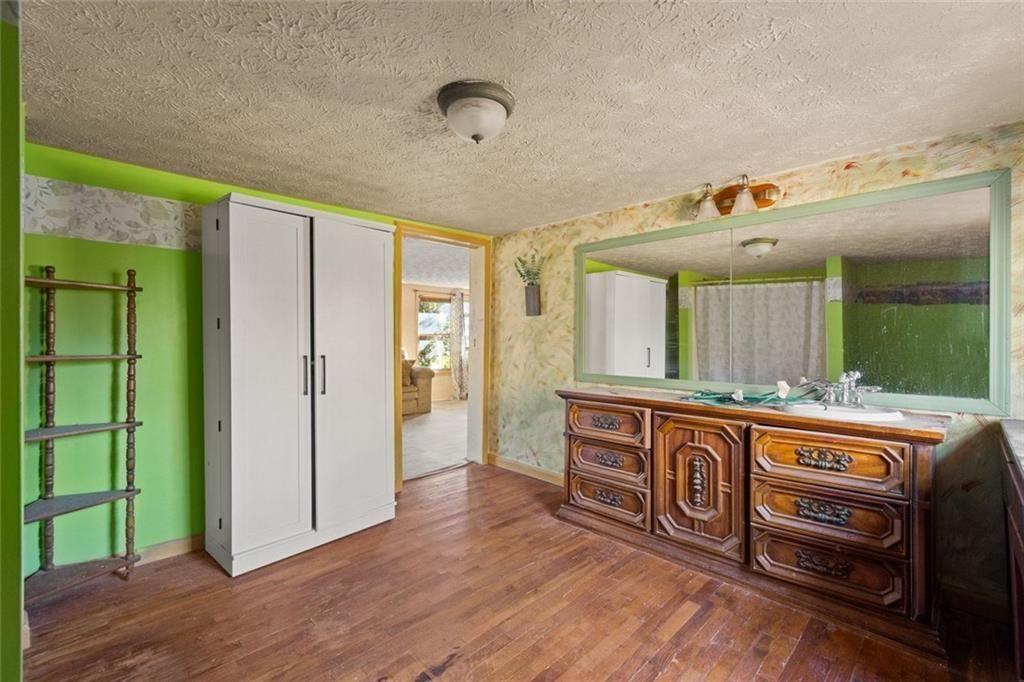 7315 Freeman Road Dawsonville, GA 30534 - Photo 23 of 28 a spacious bathroom with a sink and a mirror