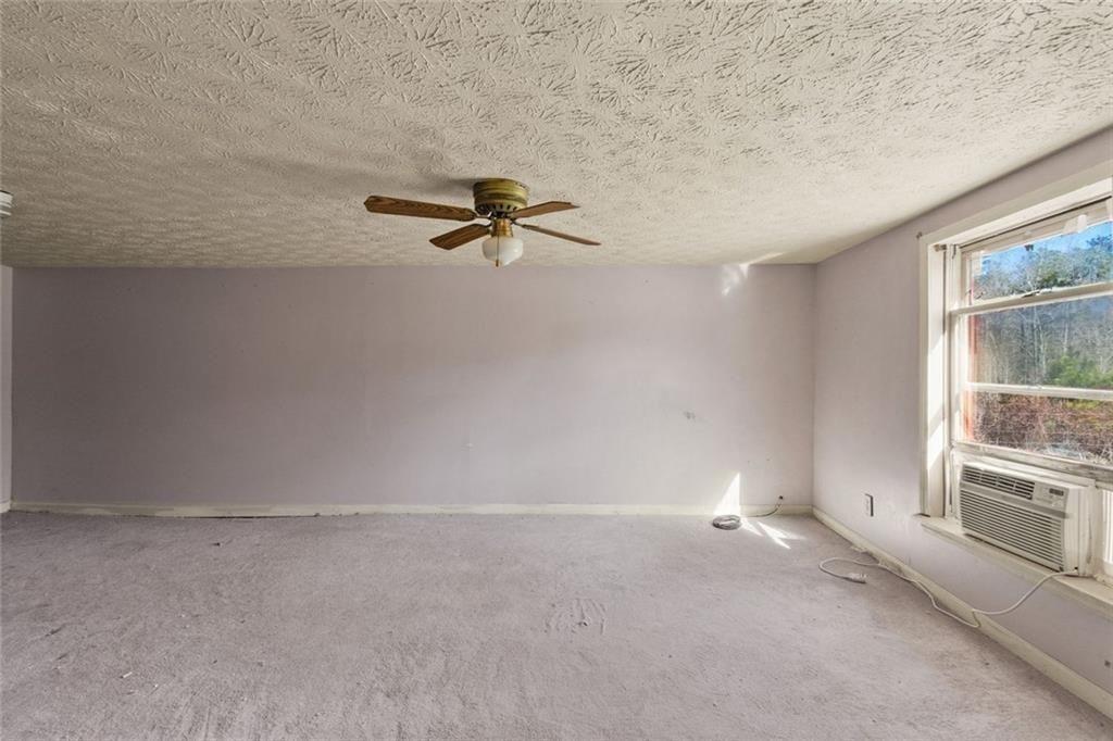 7315 Freeman Road Dawsonville, GA 30534 - Photo 24 of 28 a view of a room with a fireplace and windows