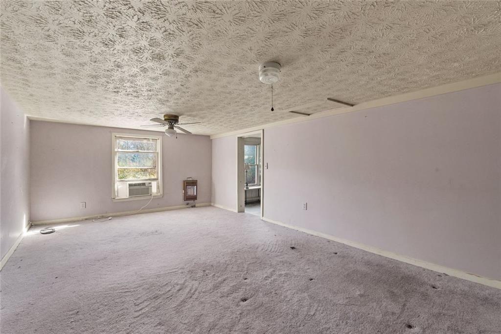 7315 Freeman Road Dawsonville, GA 30534 - Photo 26 of 28 a view of a big room with windows and chandelier fan