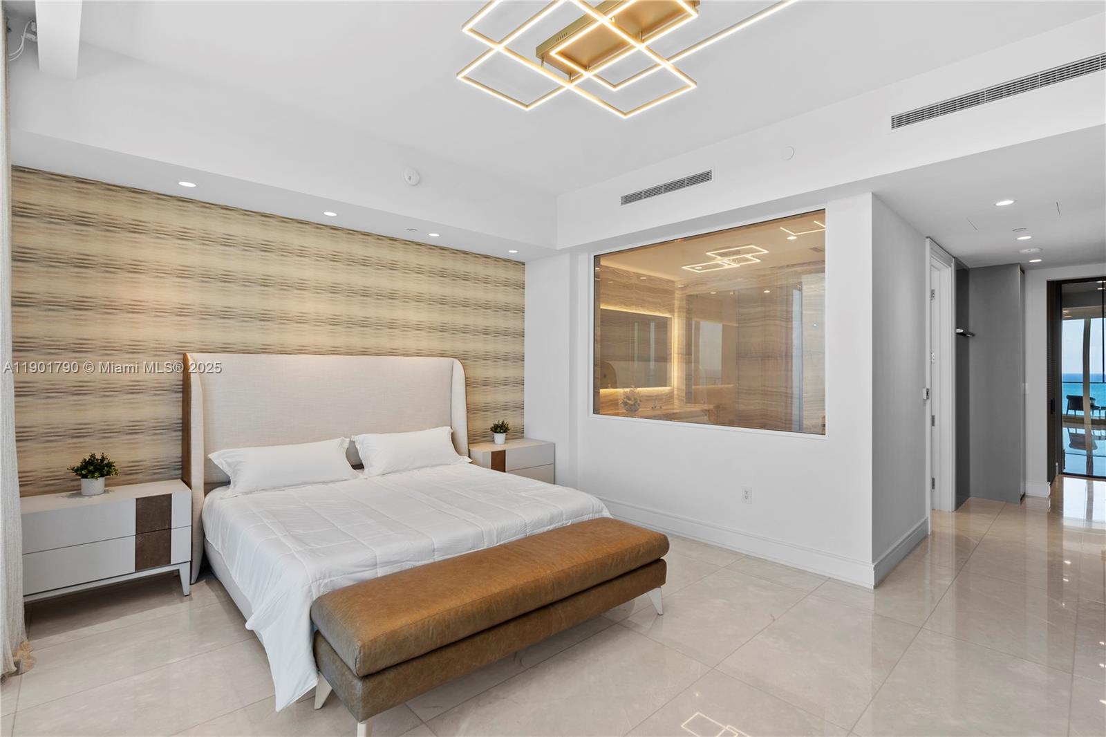 17901 Collins Avenue, Unit 1803 Sunny Isles Beach, FL 33160 - Photo 15 of 57 a bedroom with a bed and a large window