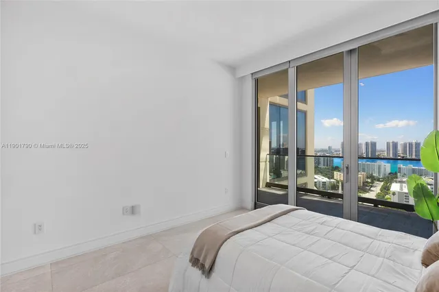 a bedroom with a bed and a large window