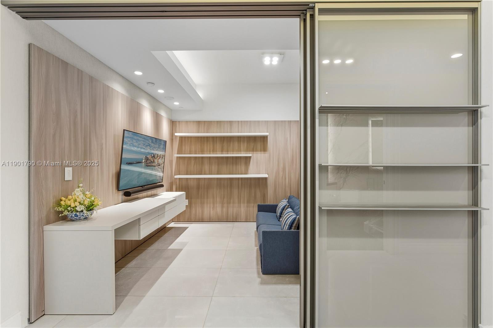 17901 Collins Avenue, Unit 1803 Sunny Isles Beach, FL 33160 - Photo 23 of 57 a living room with furniture and a flat screen tv