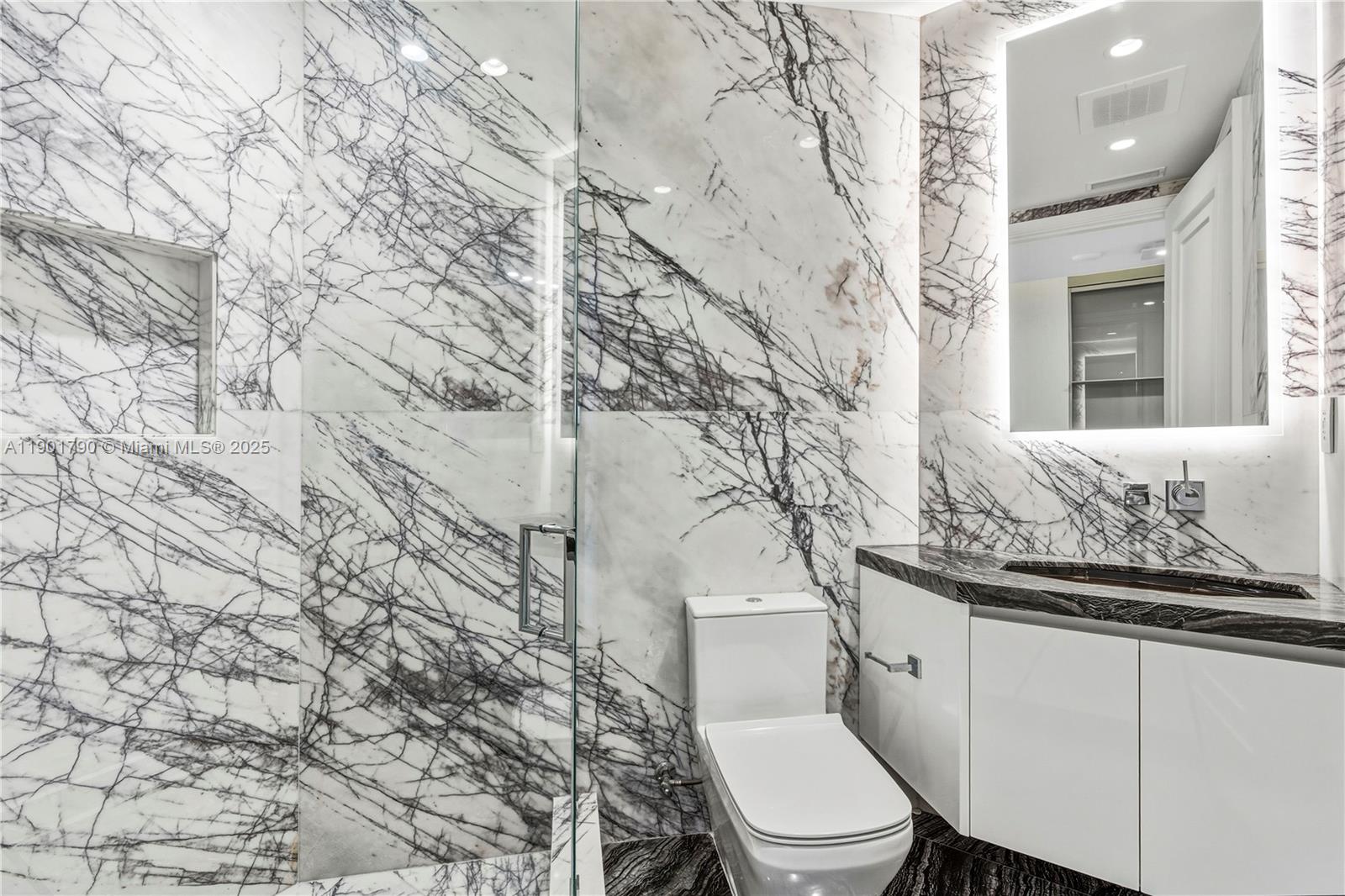 17901 Collins Avenue, Unit 1803 Sunny Isles Beach, FL 33160 - Photo 25 of 57 a white toilet sitting next to a shower