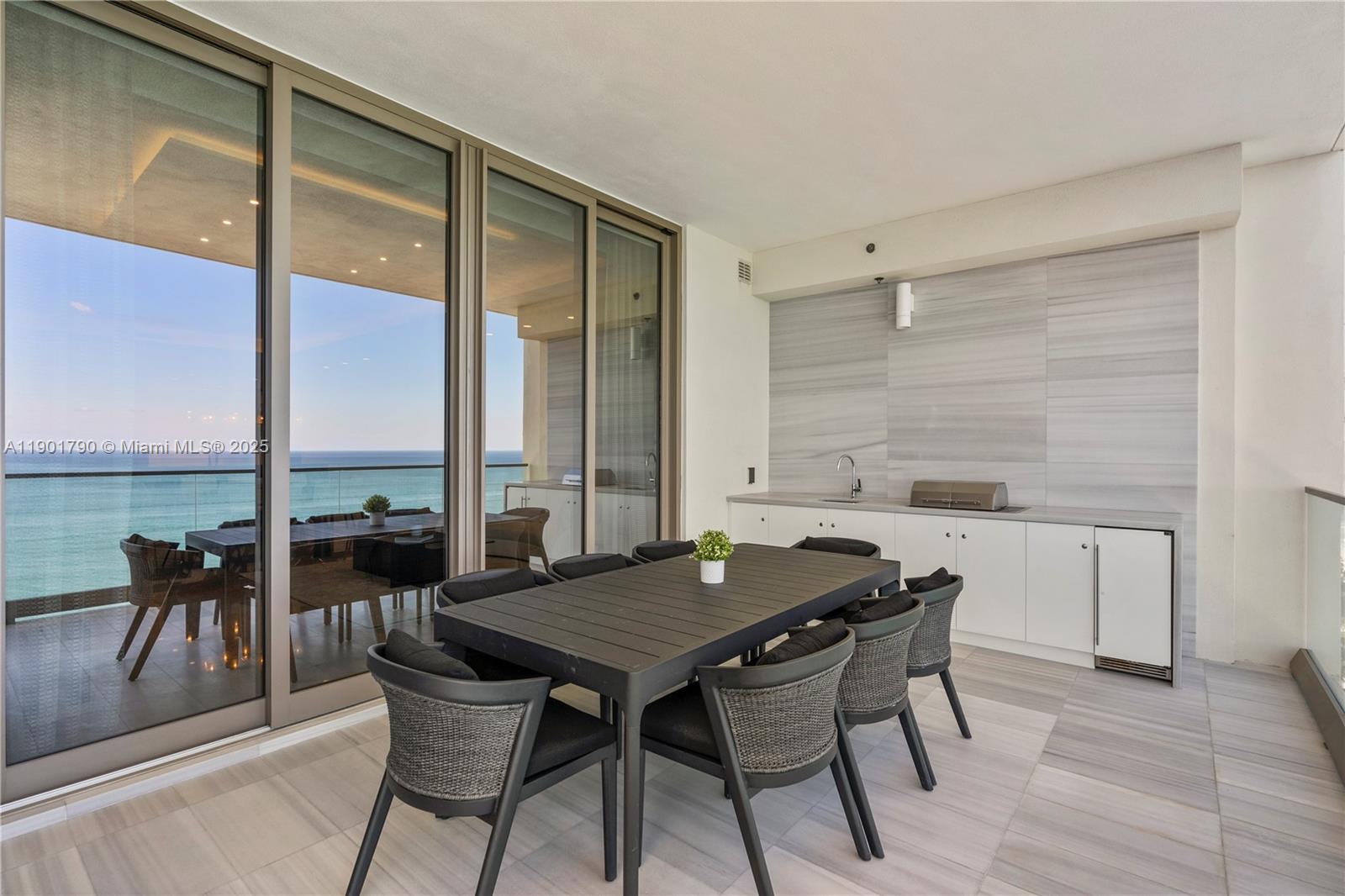 17901 Collins Avenue, Unit 1803 Sunny Isles Beach, FL 33160 - Photo 26 of 57 a view of a dining table and chairs in the balcony