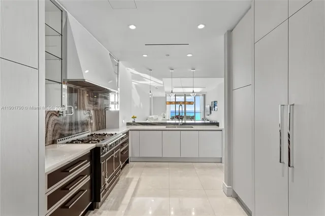 a kitchen with stainless steel appliances granite countertop a stove and a refrigerator
