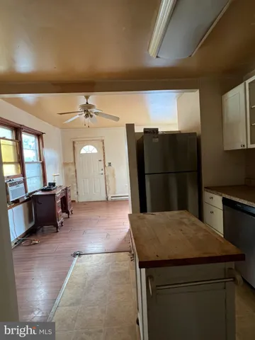a kitchen with refrigerator and window
