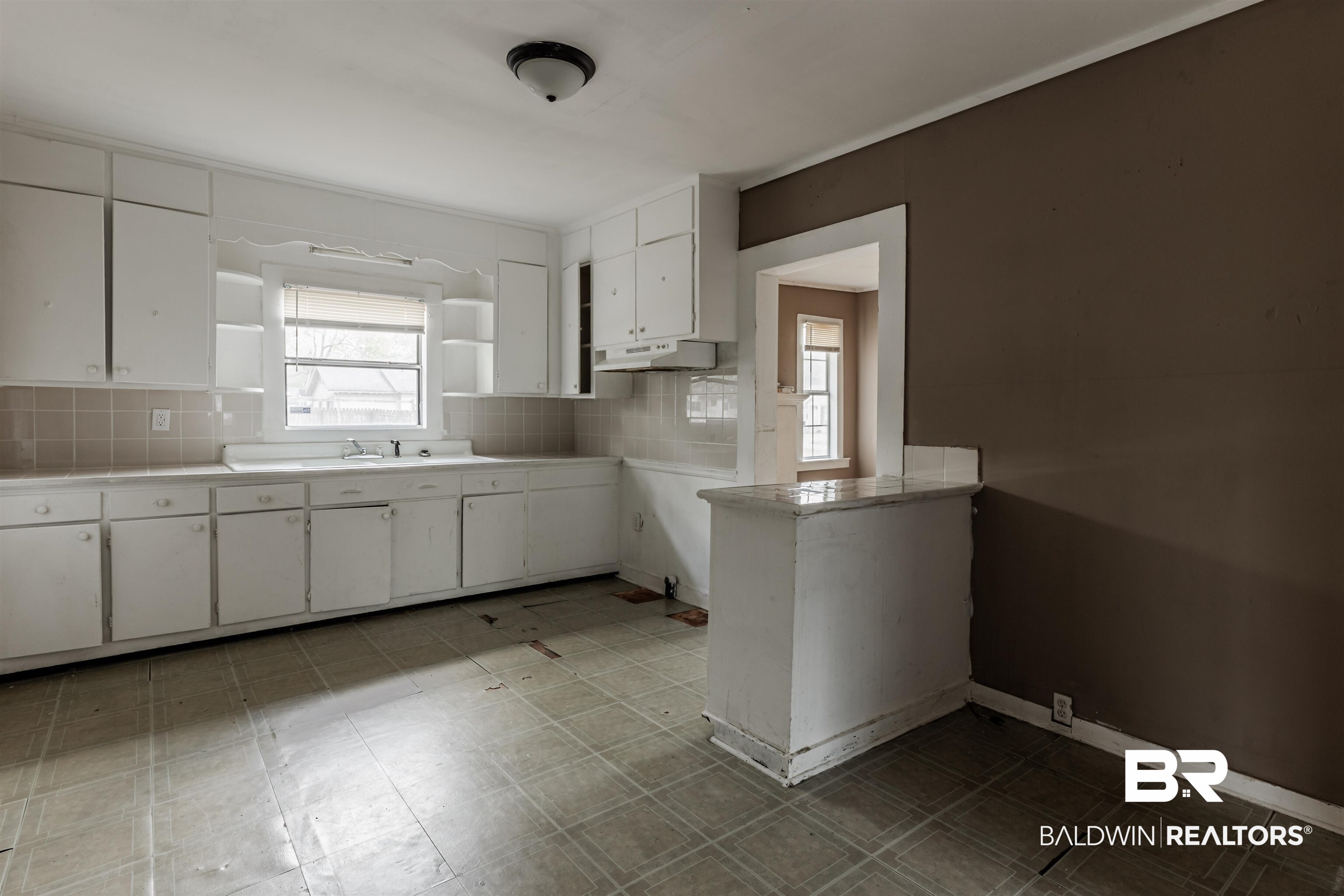 600 Mohawk Street Mobile, AL 36606 - Photo 13 of 20 Kitchen with white cabinetry and backsplash
