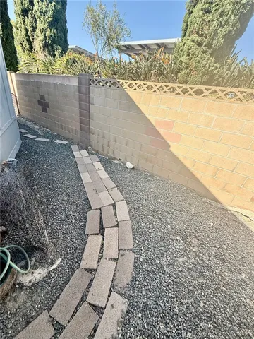 a view of a dry yard with wooden fence