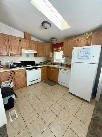 a kitchen with a stove a sink dishwasher and a refrigerator