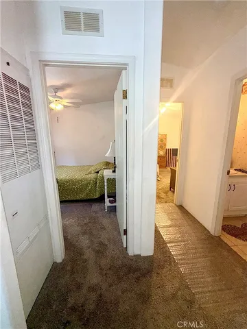 a view of a bedroom from a corridor