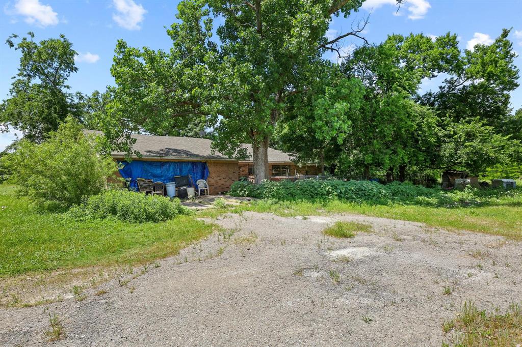 747 Vineyard Road Gunter, TX 75058 - Photo 28 of 32 a front view of a house with garden and trees
