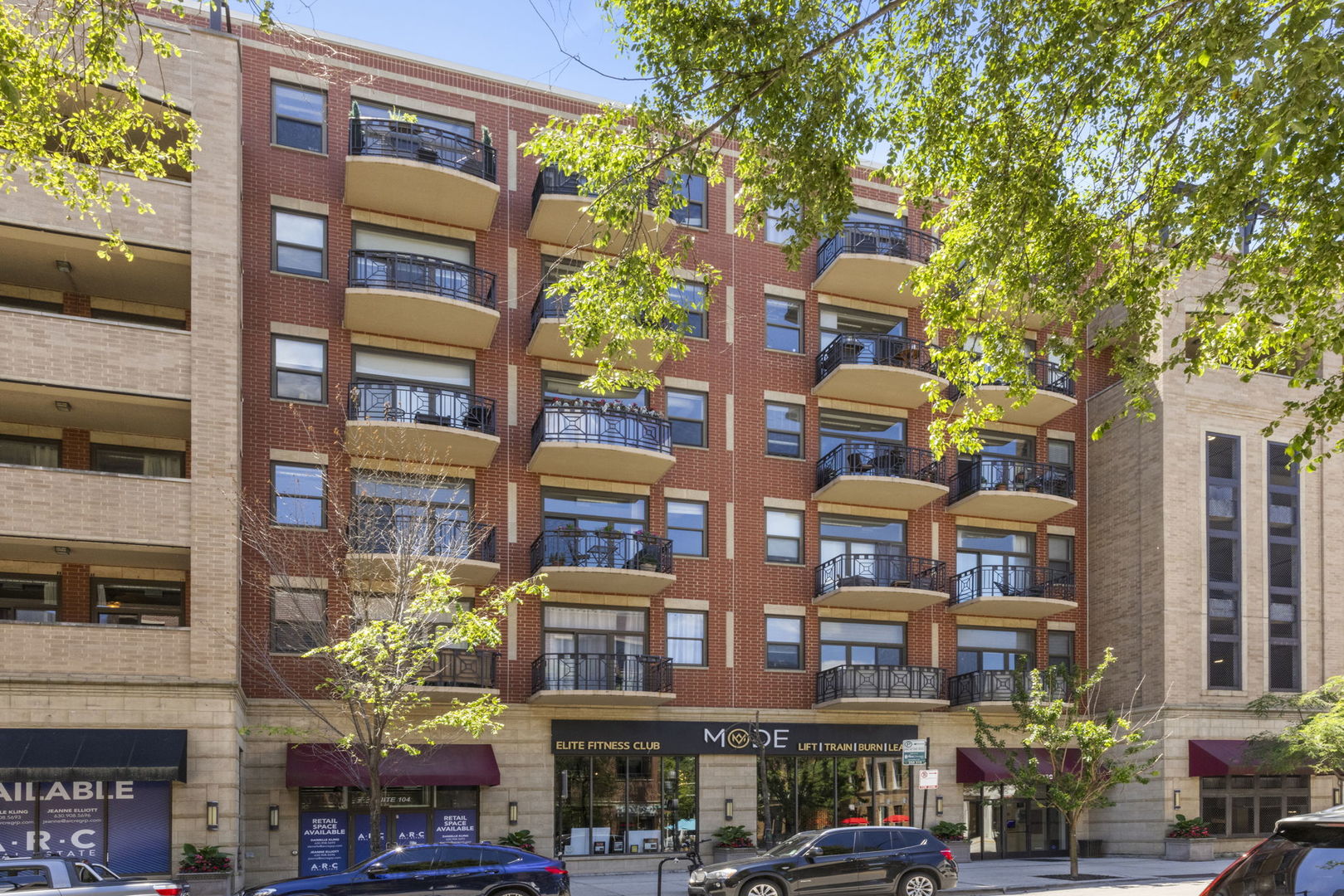 1301 West Madison Street, Unit 305 Chicago, IL 60607 - Photo 2 of 22 a front view of a multi story building with a yard