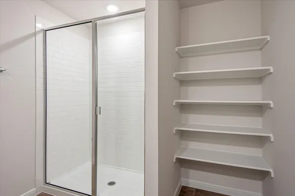a view of walk in closet with empty racks
