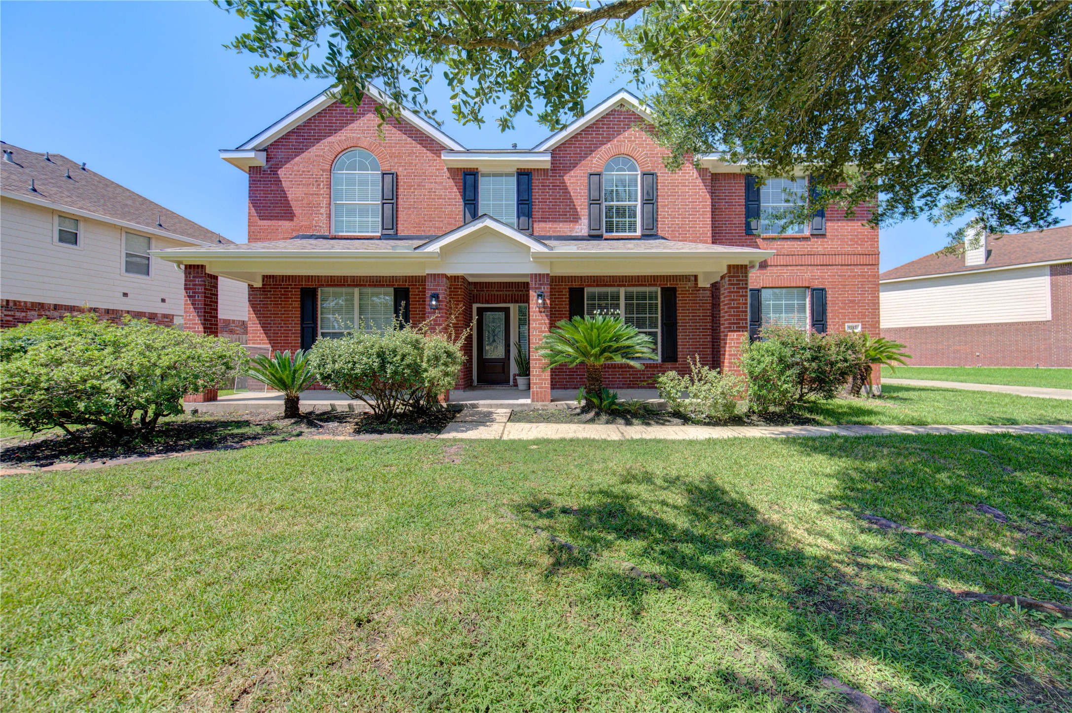 a front view of house with yard and green space