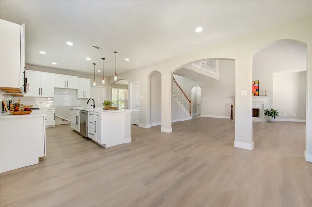 a view of kitchen with kitchen island and stainless steel appliances