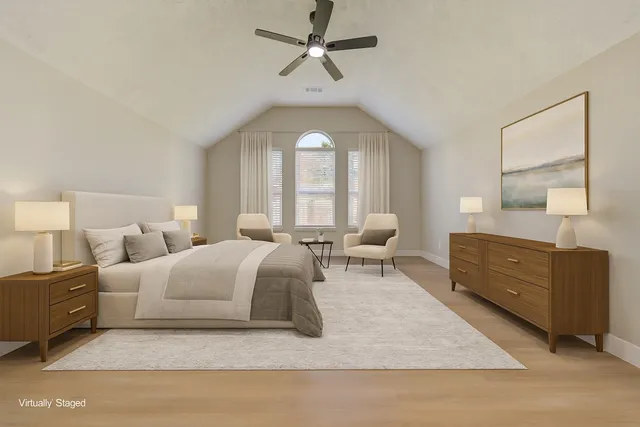 a living room with furniture a large window and a chandelier