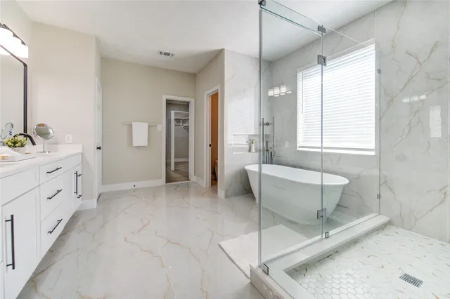 a bathroom with a tub sink and mirror