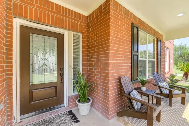 a view of a house with backyard and sitting area