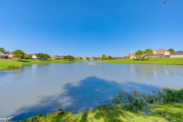 a view of a lake with houses in the back