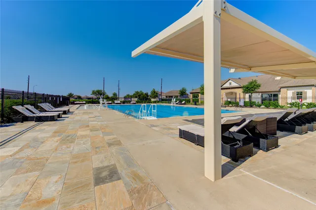 a view of a patio with a table and chairs