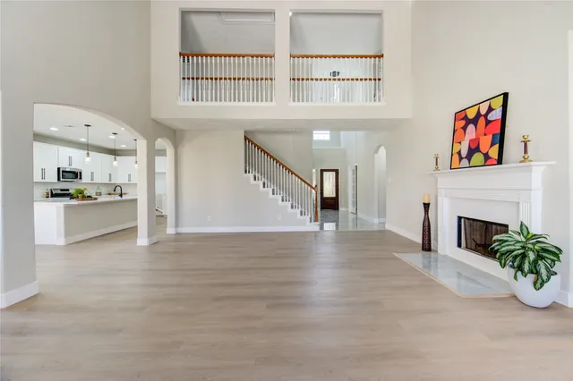 a view of an empty room with a fireplace and a window