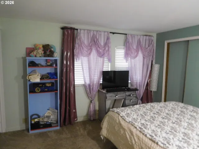 a bedroom with a bed and a lamp