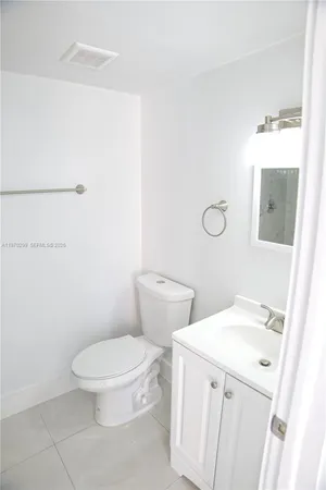 a white toilet sitting next to a bathroom sink