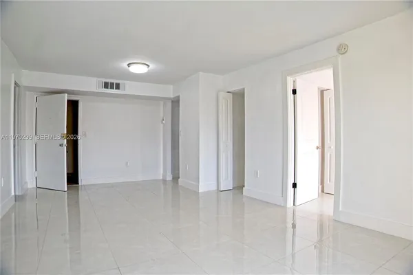 an empty room with closet area