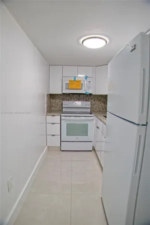 a kitchen with stainless steel appliances a refrigerator and a stove top oven