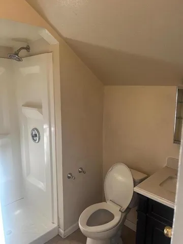 a bathroom with a toilet a sink and shower