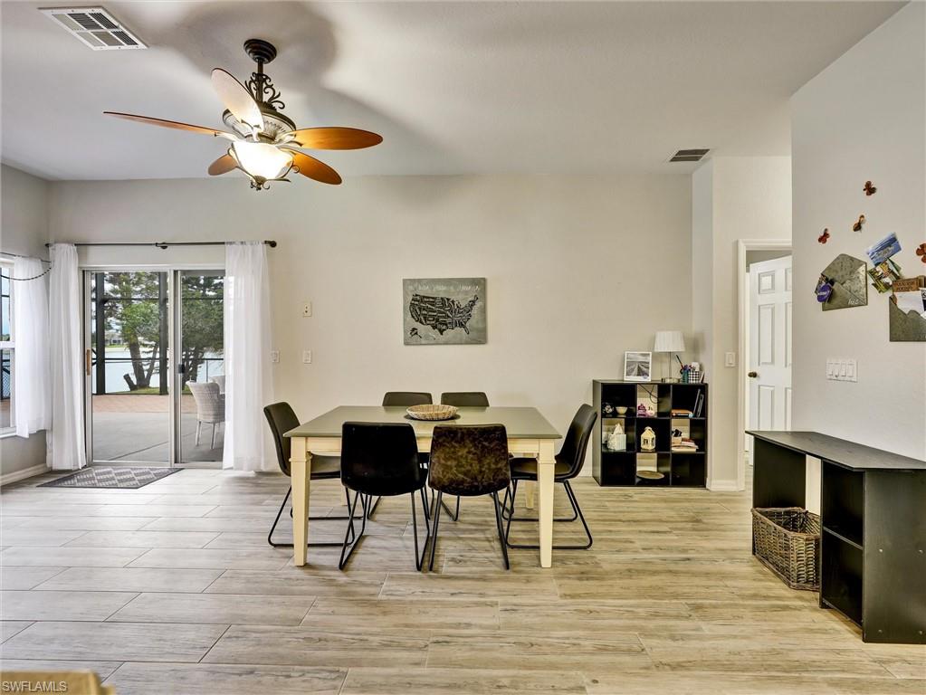 2941 Inlet Cove Lane East Naples, FL 34120 - Photo 15 of 50 a view of a dining room with furniture and wooden floor