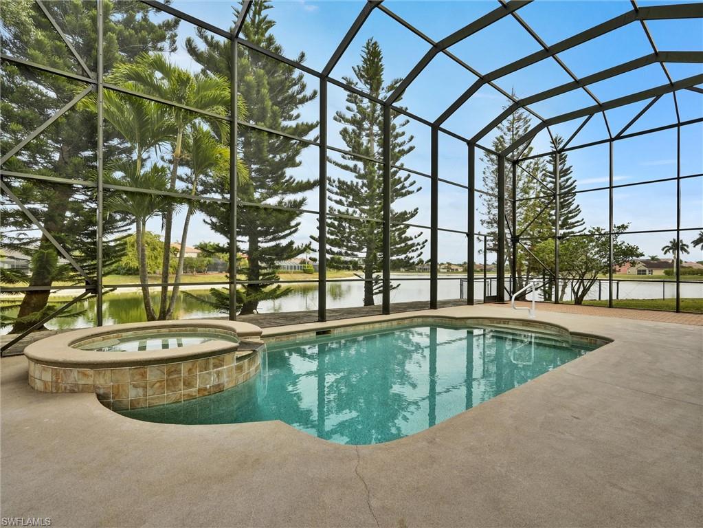 2941 Inlet Cove Lane East Naples, FL 34120 - Photo 17 of 50 a view of a swimming pool with a yard