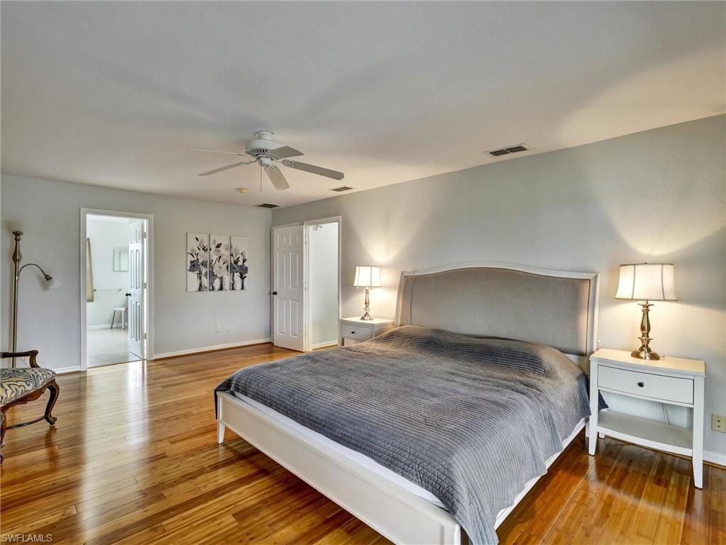 2941 Inlet Cove Lane East Naples, FL 34120 - Photo 22 of 50 a bedroom with a bed and a ceiling fan