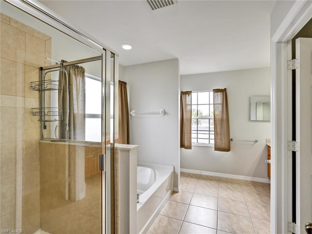 2941 Inlet Cove Lane East Naples, FL 34120 - Photo 27 of 50 a bathroom with a tub shower and sink