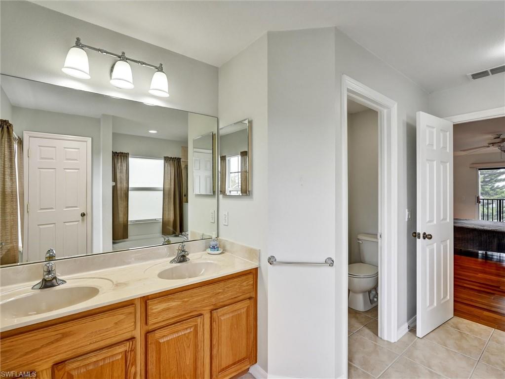2941 Inlet Cove Lane East Naples, FL 34120 - Photo 28 of 50 a bathroom with a granite countertop sink and a mirror