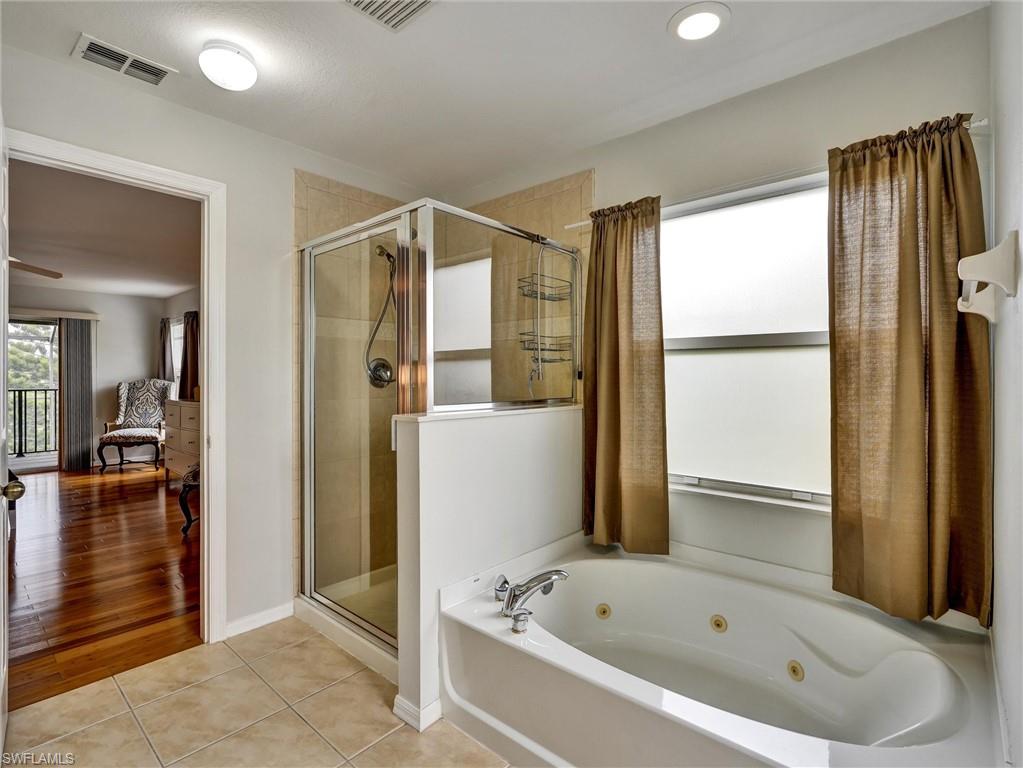 2941 Inlet Cove Lane East Naples, FL 34120 - Photo 29 of 50 a bathroom with a bathtub and a shower