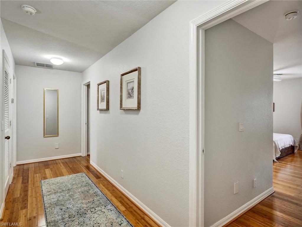 2941 Inlet Cove Lane East Naples, FL 34120 - Photo 35 of 50 a view of hallway with window and wooden floor